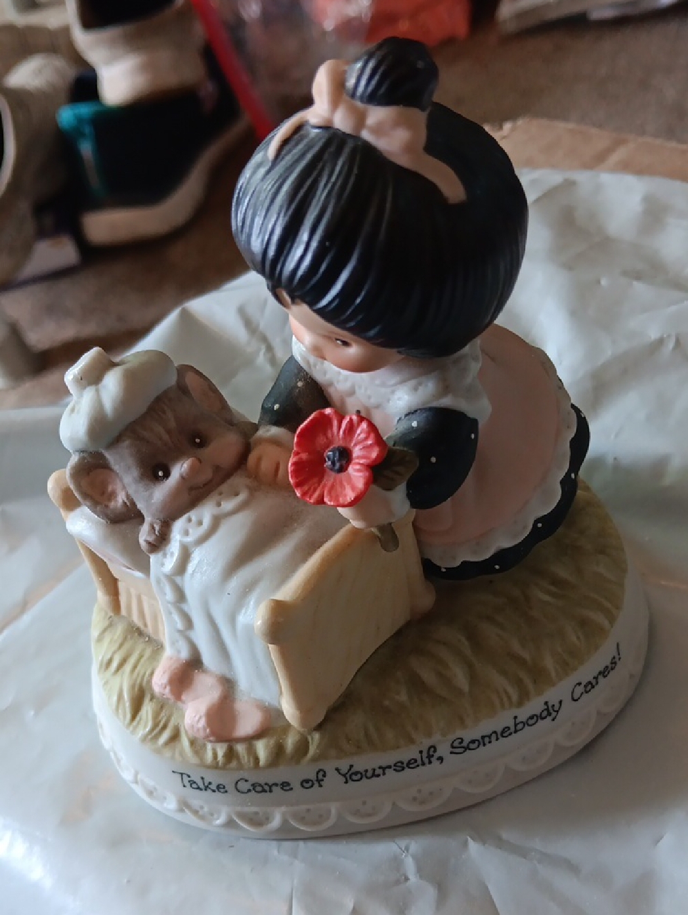 Pink and Black Ceramic Figurine - Caregiver Scene